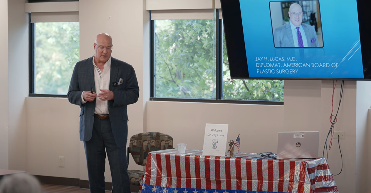 Doctor Jay Lucas giving a presentation on plastic surgery